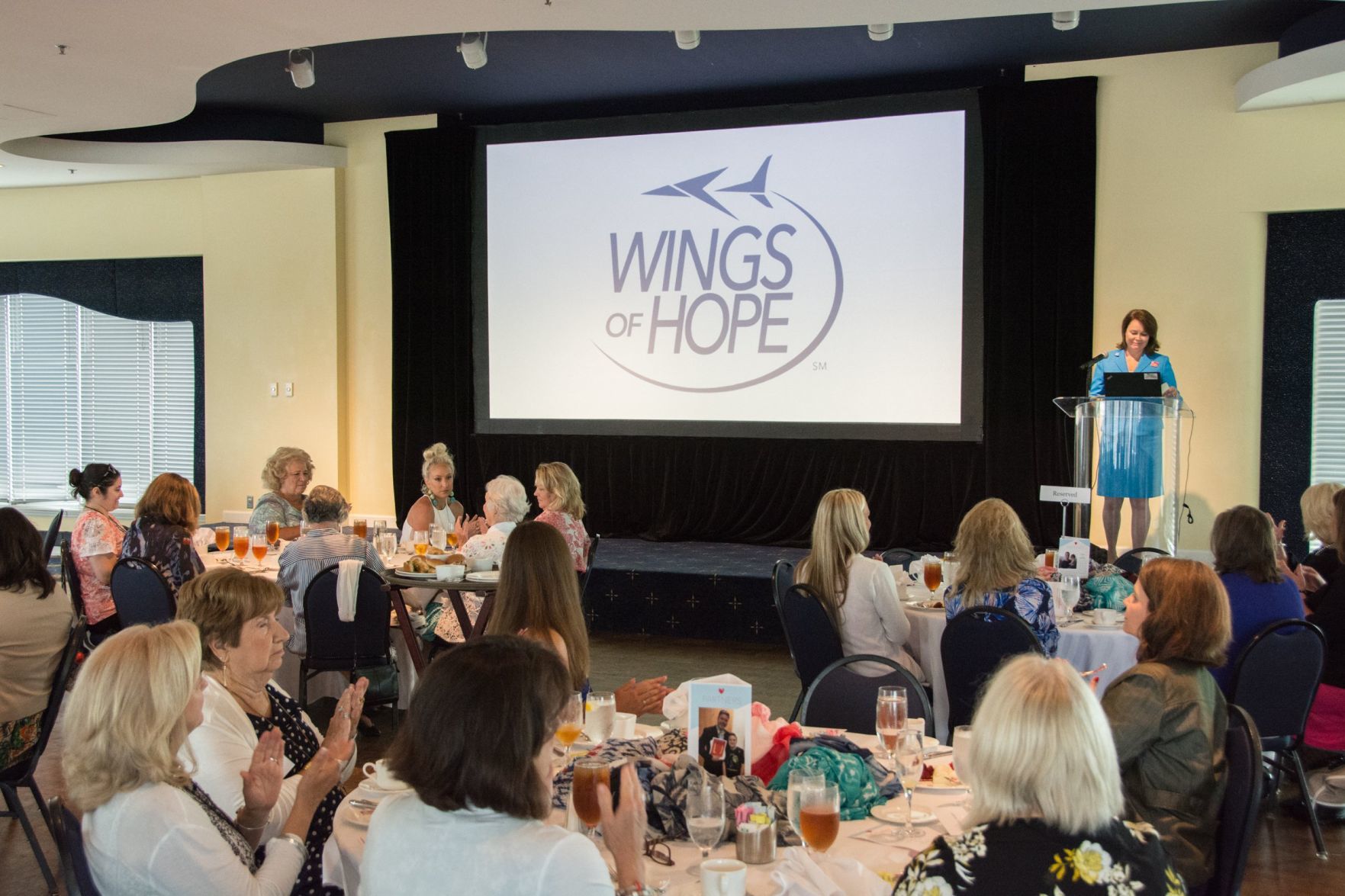 Laura Helling, Vice-President of Wings of Hope speaks to the guests in attendance